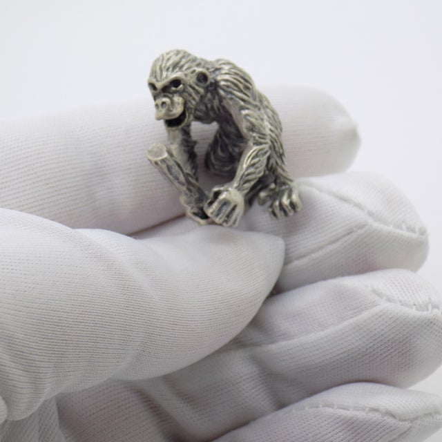 Vintage miniature sculpture with a curious, cheeky, personality packed feel, depicting a chimpanzee holding a stick,...