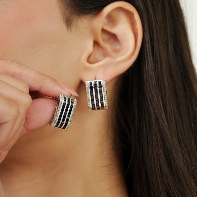 Featuring 2×2 mm square-cut blue sapphire gemstones weighing a total of 4.6 carats, accented with diamonds totaling 0.58...