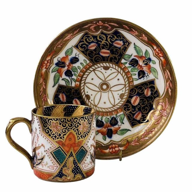 Intricate geometric fretwork and stylised lotus palmettes cover the exterior of this straight-sided demitasse can and...