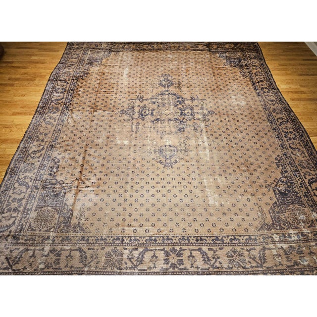 A rare treasure for collectors and designers alike, this near-square oversized vintage Turkish Oushak rug from the early...
