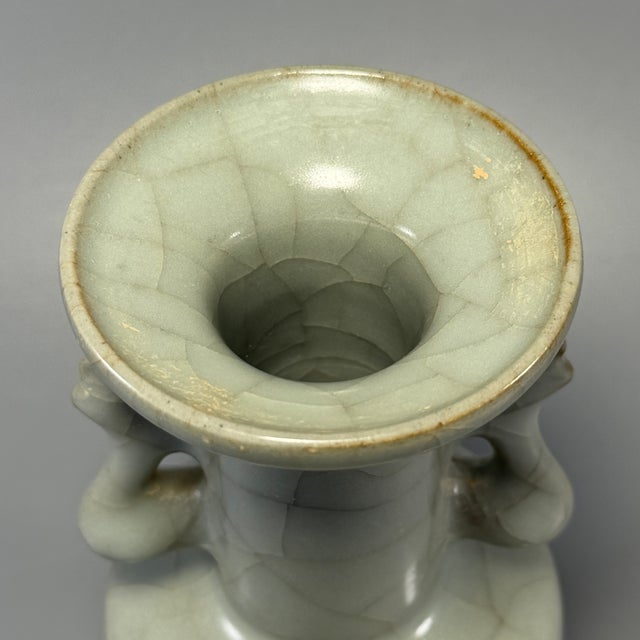 This elegant antique Chinese celadon vase is decorated with twin phoenix ears and covered with fine crackle glaze. Crafted...