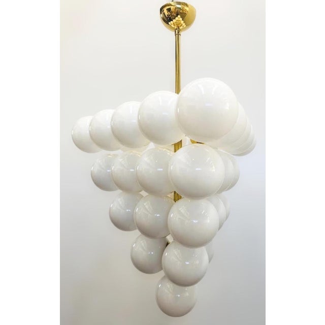 Italian chandelier with glossy white Murano glass globes mounted on polished brass finish frame / Made in Italy by Fabio...