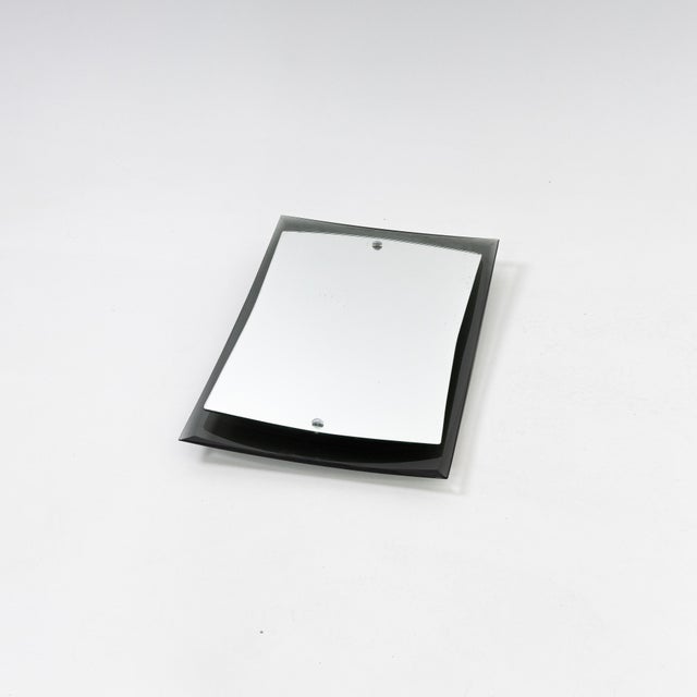 Small Italian Modernist mirror. Curved smoked glass back with floating mirror mounted on top.
