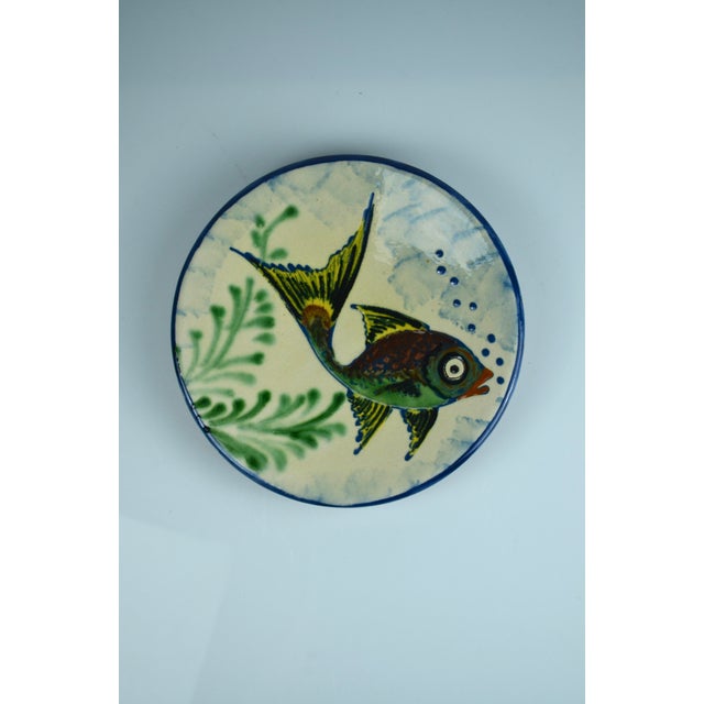 Decorative pair of hand-painted ceramic wall plates produced by Puigdemont in Spain, circa 1960s. Featuring two expressive...