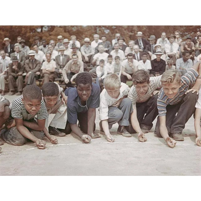Marbles Championship 1948 by Slim Aarons Slim Aarons Limited Estate Edition A group of boys competing in a marble...