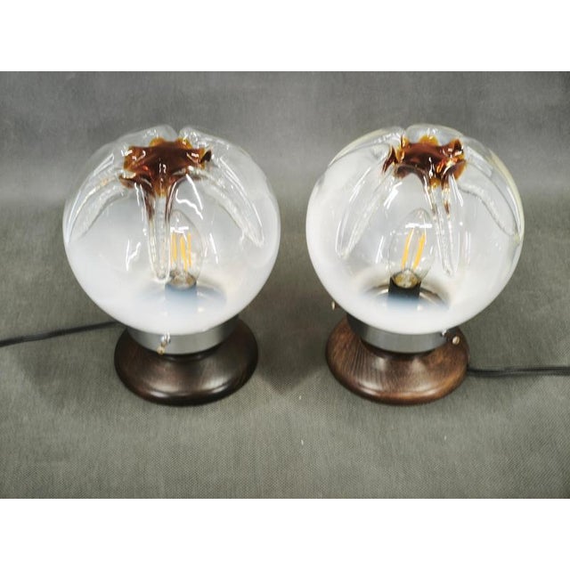 A charming pair of italian mid-century modern table lamps dating from the 1950s, distinguished by their sculptural murano...