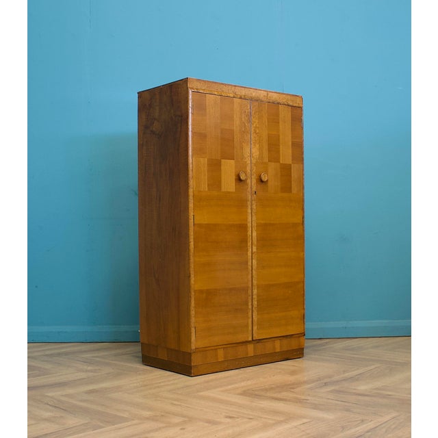 A 1930s Art Deco two-door cabinet, beautifully veneered in burr walnut and walnut with geometric veneers. Originally made...