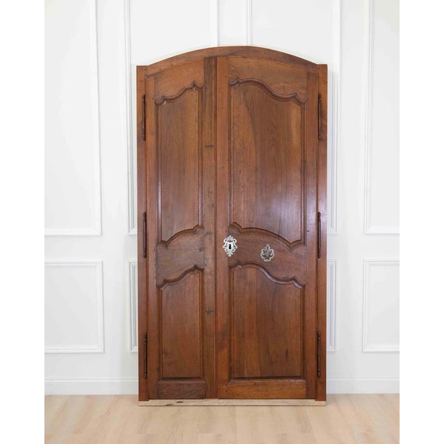Impressive pair of Louis XV style double communication doors crafted in walnut during the 19th century. These...