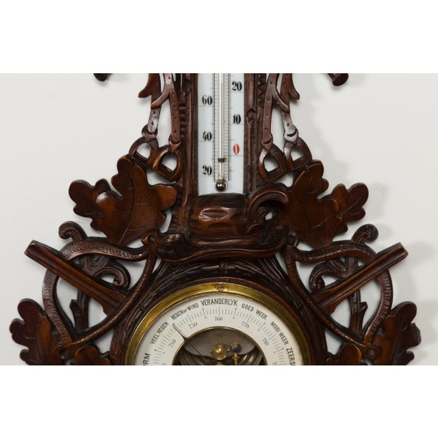 A Dutch carved wooden barometer from the late 19th century, with horse motif, signed by Gebroeders Caminada, Rotterdam....
