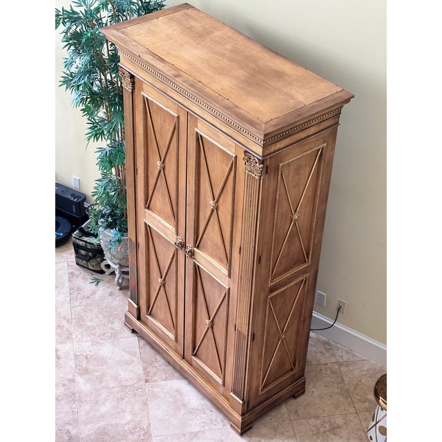 This magnificent E.J. Victor armoire perfectly exemplifies the brand's unwavering commitment to luxury, bench-made...