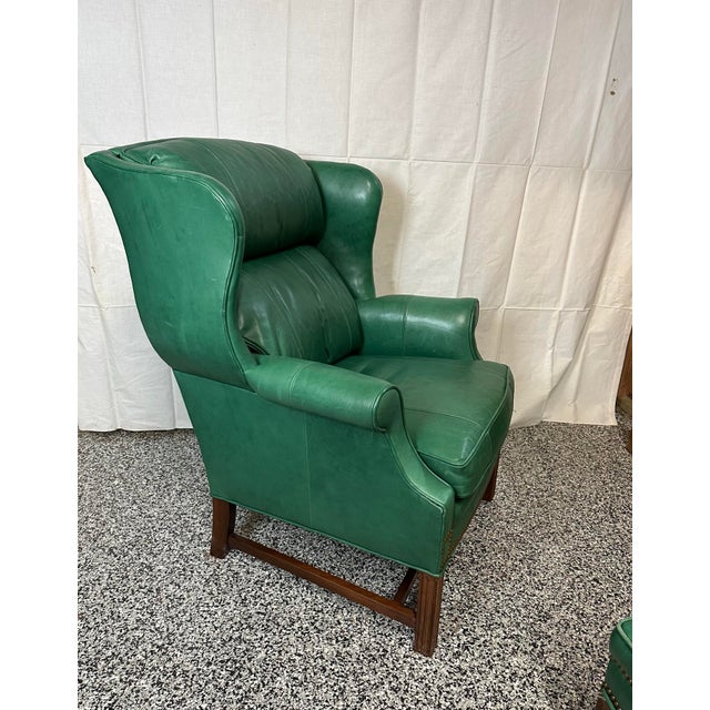 Stunning green leather Sherrill Furniture wing chair and ottoman . Chair measures 42” h x25” w x 36” d Arm height 24” Seat...