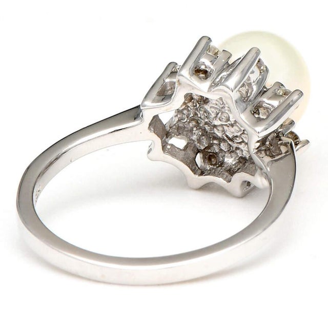 Encircle your finger with this glamorous 14K white gold halo ring. Featuring a lustrous Akoya pearl surrounded by dainty...