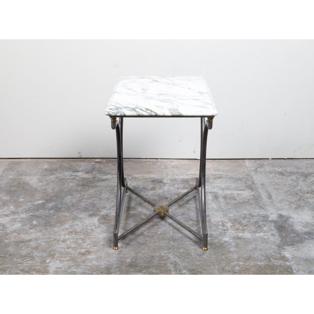 A French steel and bronze console table from the mid 20th century, with marble top and rosette medallion. Created in...