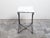 A French steel and bronze console table from the mid 20th century, with marble top and rosette medallion. Created in...
