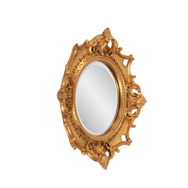 Finished in a luxurious antique gold, the ornate frame adds a touch of classic sophistication, making it a perfect accent...