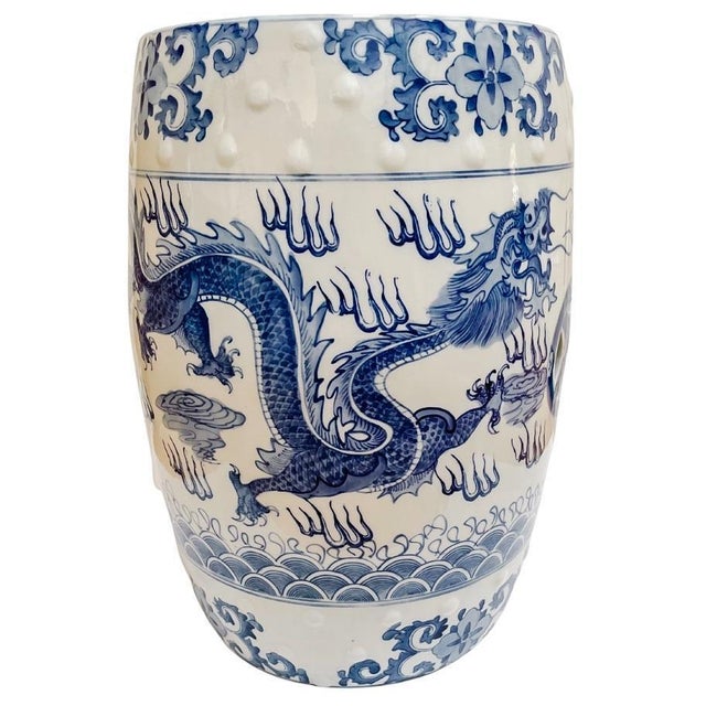 A classic and timeless blue and white porcelain garden stool featuring two dominant Chinese symbols: the Dragon which...