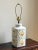 This is such a beautiful lamp! It features a tea jar-shaped base in a soft ivory glaze with a vibrant lotus flower pattern...