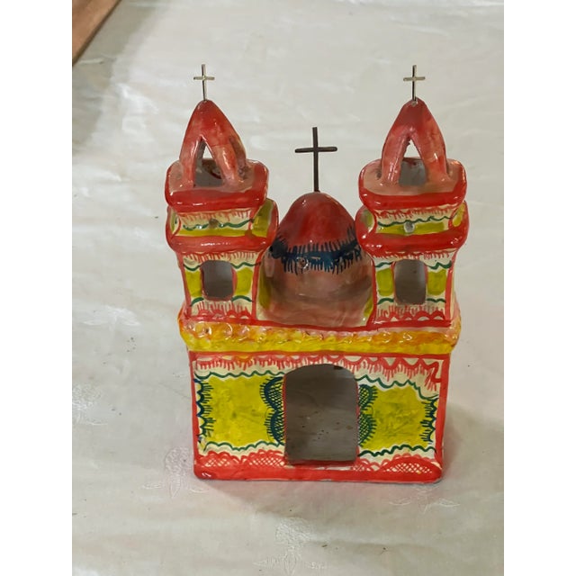 Samll Spanish Mission Church painted in full glory. There are arched windows and beautiful steeples adorned with sterling...