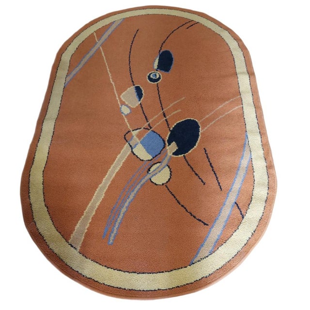 A small oval rug made from pure wool in Türkiye around the 1950s. It is made of wool with woven edge. The rug is in...