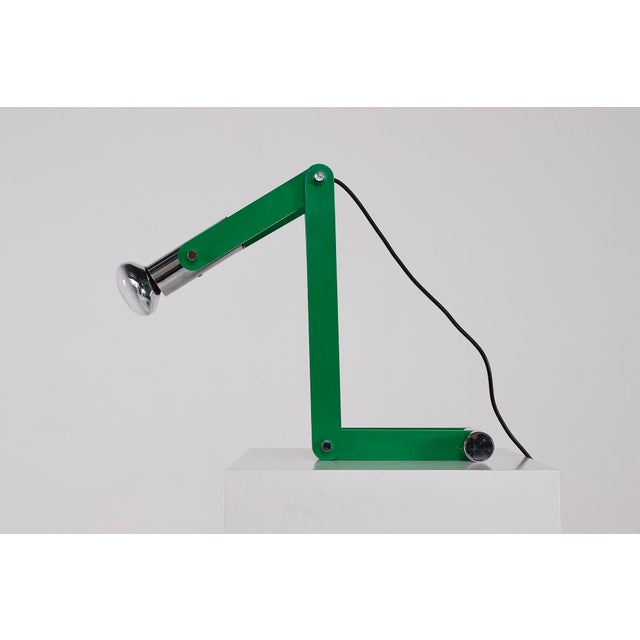 Articulated lamp composed of three green plastic segments and weighted by a chromed steel cylinder. Italian design from...