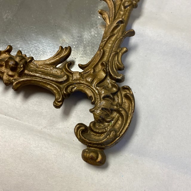 Beautiful petite metal Art Nouveau vanity mirror. Perfect to add dimension and character to any space and for the interior...