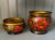 Vibrant decorative wood laquerware vessels. Red and orange berries with gold leaves on a black field. Gold interior....