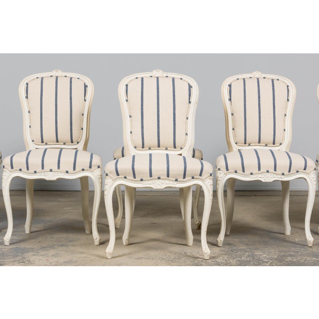 An exquisite restored set of eight late-19th-century French Provincial dining chairs in the Louis XV style, sourced in...