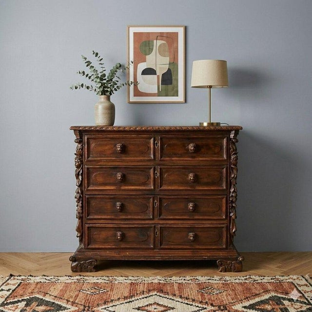 Baroque chest of drawers in walnut and poplar. The front features four bipartite drawers with carved cherub-head knobs,...