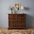 Baroque chest of drawers in walnut and poplar. The front features four bipartite drawers with carved cherub-head knobs,...