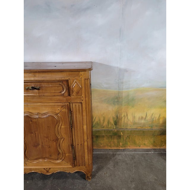 Elegant louis xv period cherrywood jam cupboard. the door is medallion-shaped and mounted on bronze hinges. the front feet...