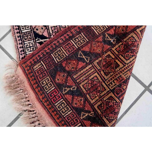 Handmade vintage Afghan Baluch rug in unusual tribal design and beautiful combination of colors. The rug is from the...
