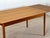 This stunning Danish teakwood extending table from the 1960s showcases the timeless elegance and craftsmanship of mid-...