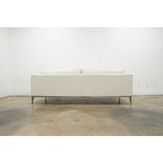 Designed by acclaimed interior designer Martyn Lawrence Bullard for Frontgate, this white leather sofa embodies the...