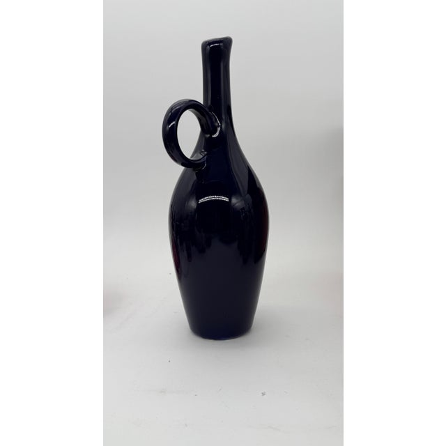 Deep blue vase with a jug handle made by Royal Haeger. Nice deep blue with a touch of purple.