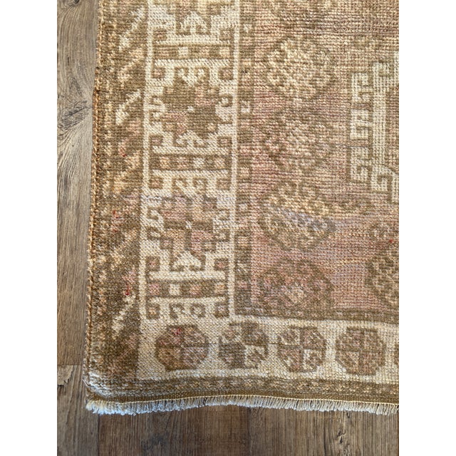 A lovely vintage Anatolian rug. This vintage Anatolian offers a neutral beige palette with brown and blush accents.