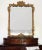 A beautifully crafted antique French Rococo Revival mirror featuring richly detailed gesso ornament and an elegant...
