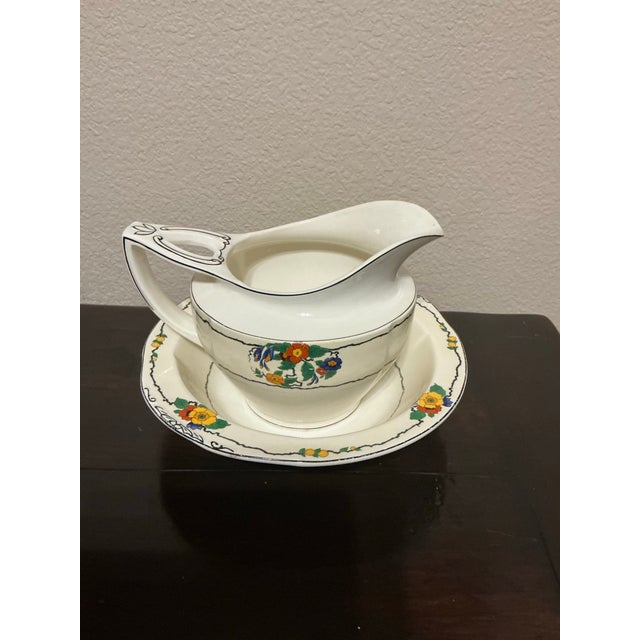 A charming antique English gravy boat and matching underplate crafted by W.H. Grindley & Co. in the sought-after Chelsea...