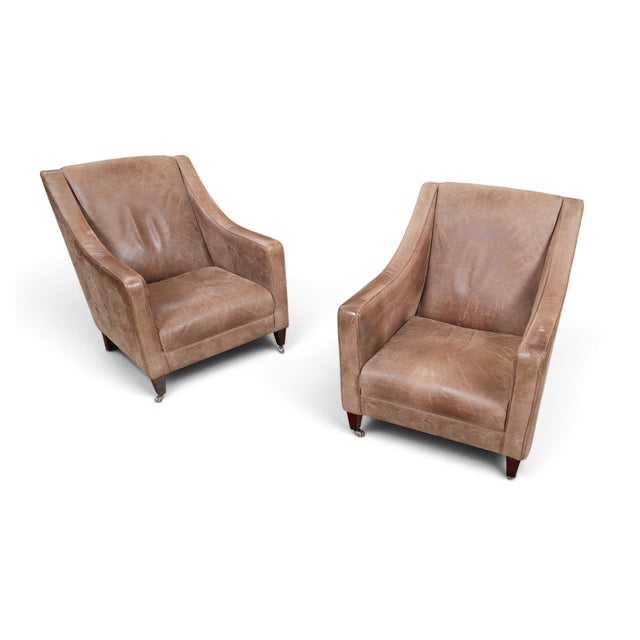 This is an exceptional pair of "Shelby" sloped arm club chairs by legendary British furniture maker, Tetrad International...