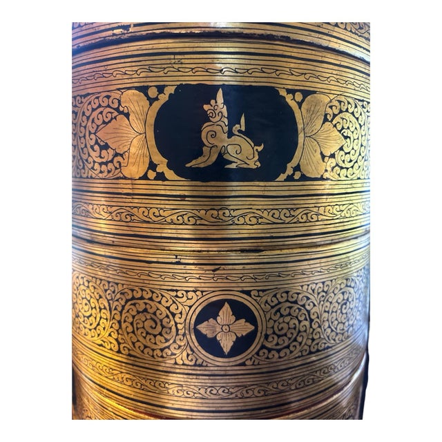 This Vintage Lacquered Ceremonial Food Carrier, known as a Tiffin, is made of wood with a luxurious gold color. This...