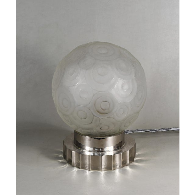 SABINO A gorgeous French 1925-1930 art deco table lamp in nickel plated solid brass or bronze holding a small sphere in...