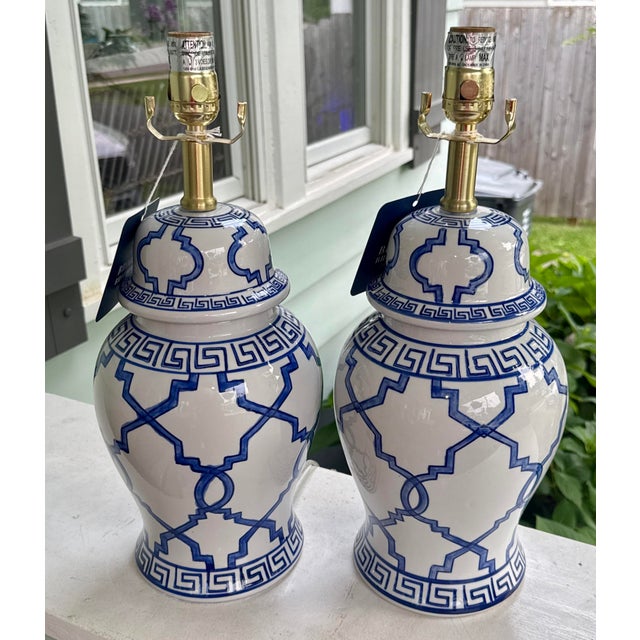 Classic blue and white ginger jar lamps featuring a bold geometric lattice pattern paired with a Greek key border. These...