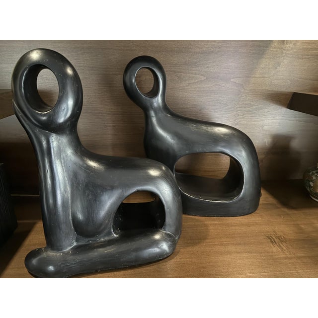 This striking pair of abstract modernist sculptures features fluid, organic forms with smooth, continuous curves and open...