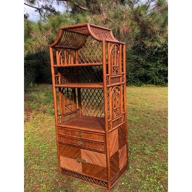 Fantastic piece with weaved rattan shelves. Penci reed detail with Brighton pavilion style rattan details Two draws and a...