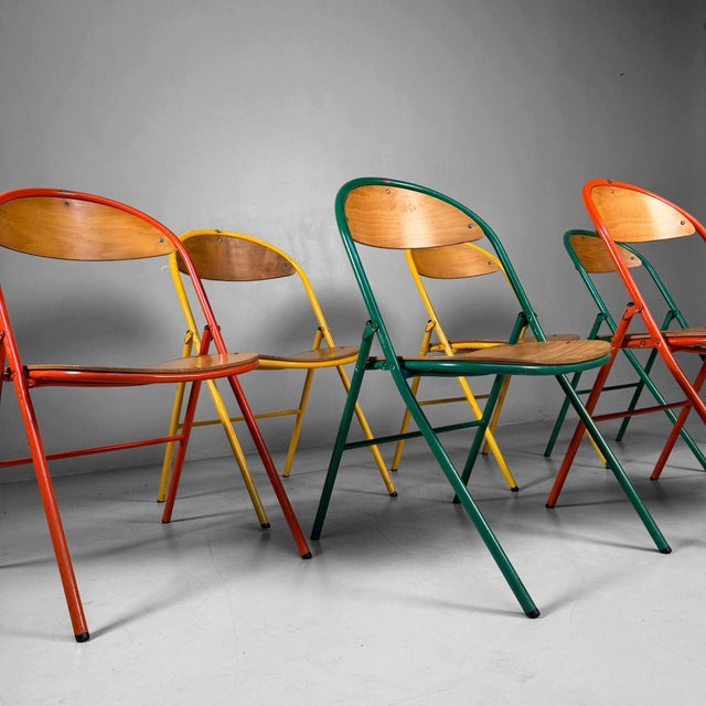 Colourful set of six vintage folding chairs from the 1970s, featuring slender metal frames in yellow, green and orange...