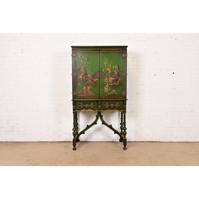 A gorgeous antique Chinoiserie Jacobean style bookcase, dining cabinet, or bar cabinet In the manner of Berkey & Gay USA,...