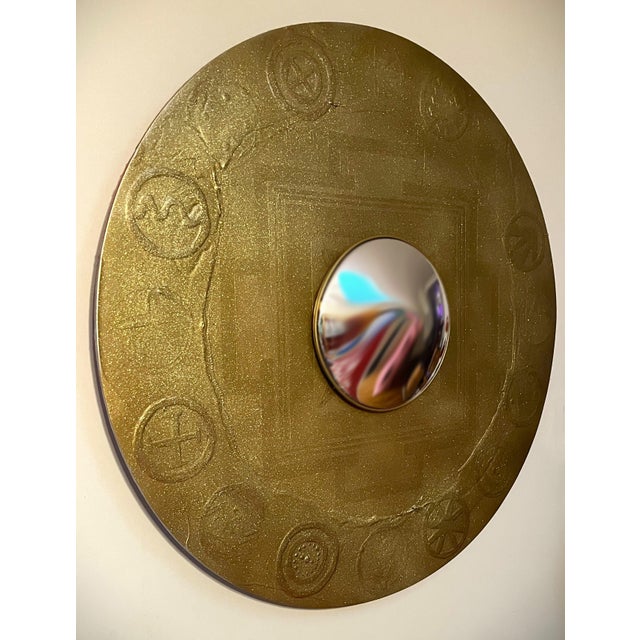 This large scale wall mounted gold mandala features a mirror eye and subtly raised relief, ornaments, and nuanced...