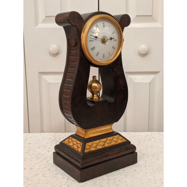 A contemporary mantle clock fashioned after the French gold lyre mantle clocks of the 18th and 19th centuries. Cost $599.