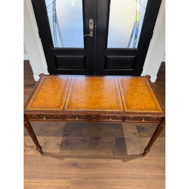 A finely crafted leather-top writing desk by Maitland-Smith, showcasing the brand's renowned attention to detail and...
