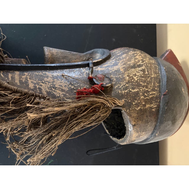 This is a rare fang mask from Gabon . It is made out wood, fiber and beads. It is a mixture of black , tan and red in...