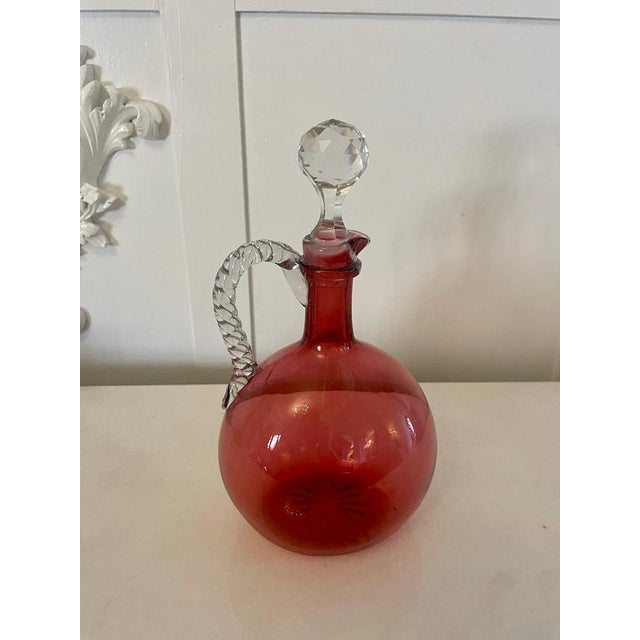 Antique Victorian quality cranberry glass decanter having an unusual rope twist glass handle and original stopper A quaint...